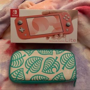 Coral Nintendo Switch Lite with extras